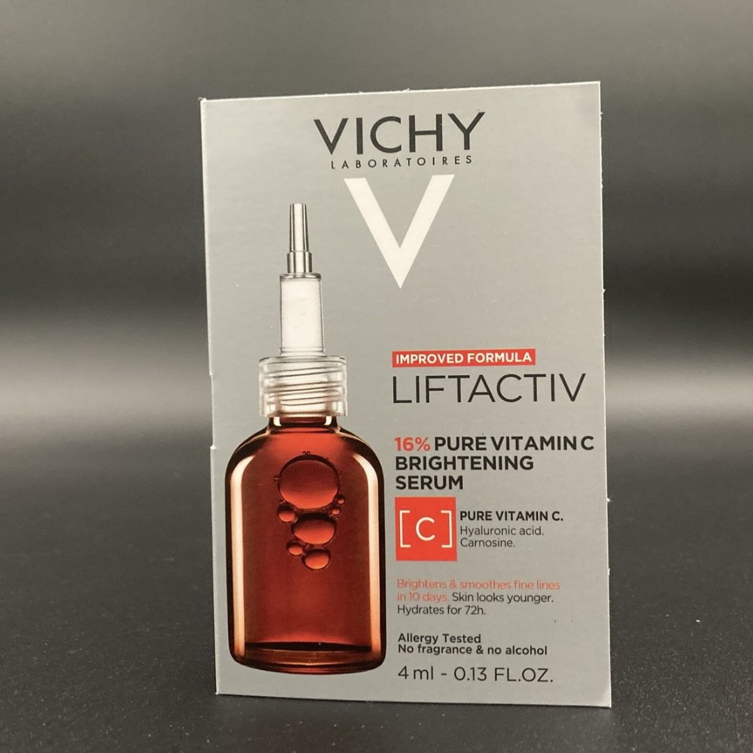 Model applying Vichy LiftActiv 16% Pure Vitamin C Serum to her cheek, demonstrating targeted application for brightening dull skin