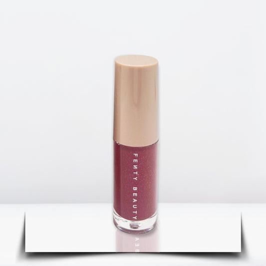 "Fenty Beauty Gloss Bomb Riri 2mL bottle for high shine and hydration."
